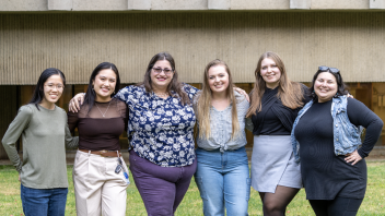 6 individuals smiling at camera