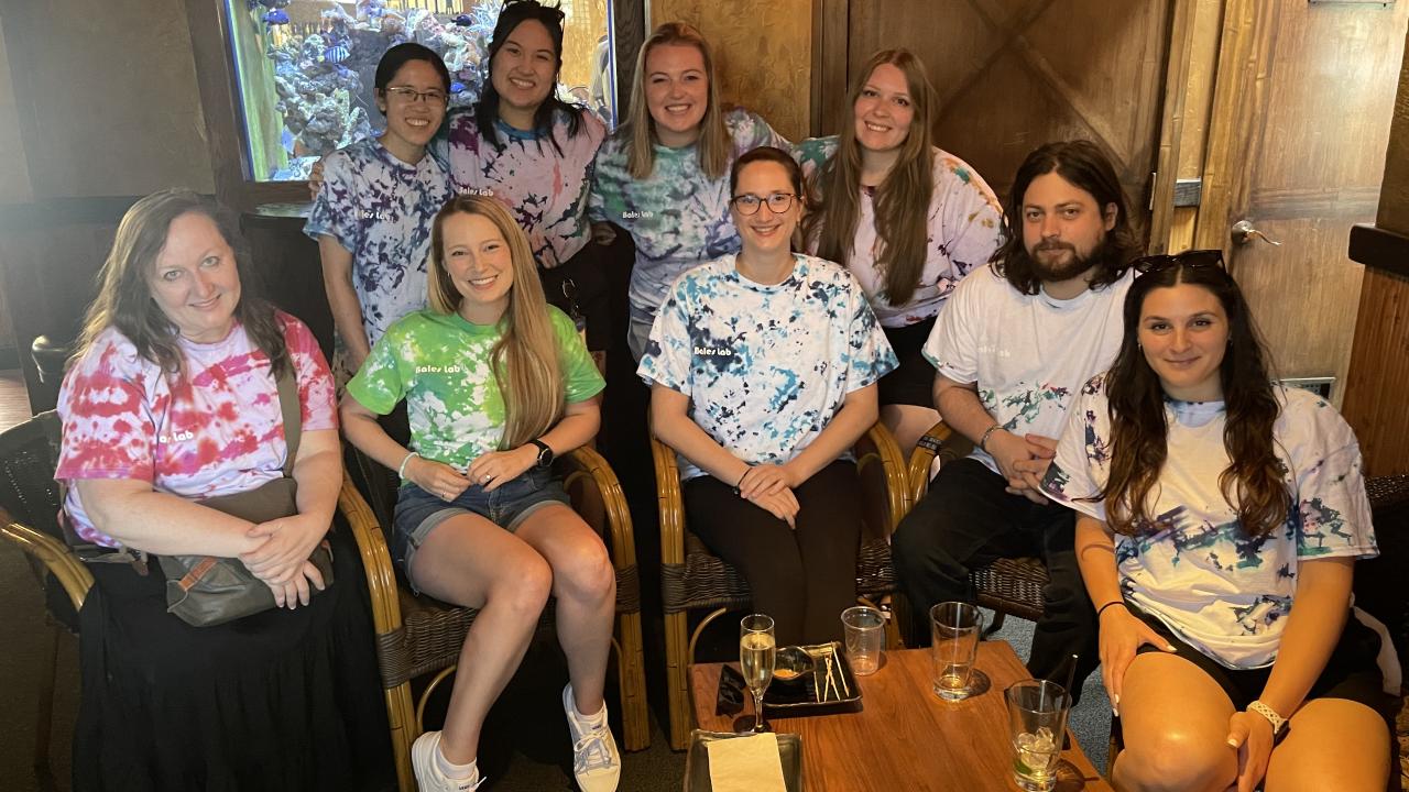 Bales lab personnel gathered around Isabel Kier in matching tie-dyed t-shirts
