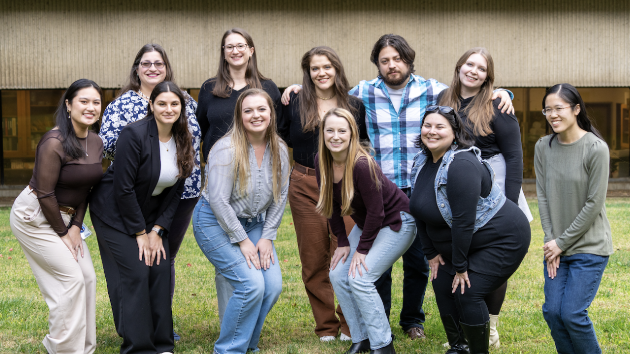 Eleven individuals smiling